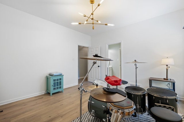 sitting room with light wood-type flooring and a chandelier