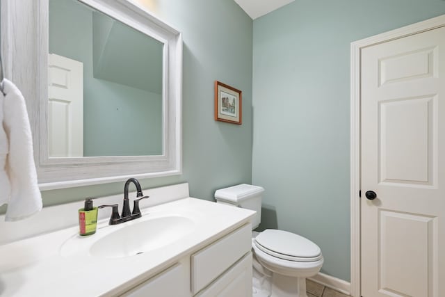 bathroom featuring vanity, toilet, and tile patterned floors