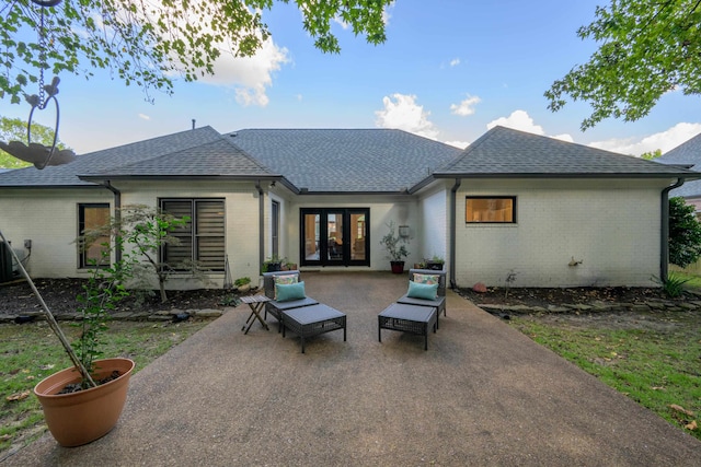 rear view of property with a patio area and french doors