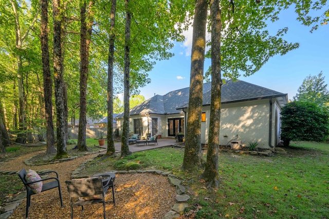 back of house featuring a patio and a lawn