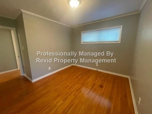 empty room with crown molding and hardwood / wood-style floors