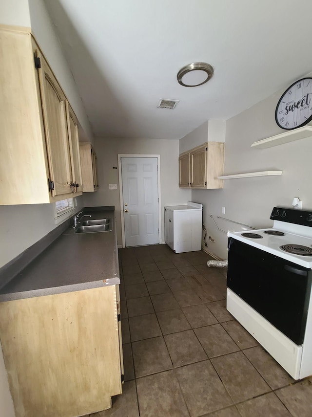 kitchen featuring dark tile patterned flooring, light brown cabinetry, electric stove, and sink