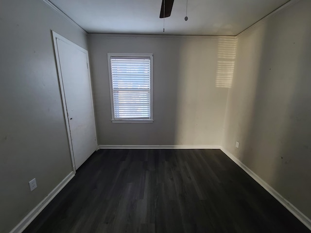 unfurnished room with ceiling fan, dark hardwood / wood-style floors, and ornamental molding