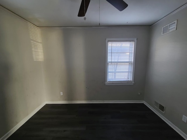 empty room with ornamental molding, ceiling fan, and dark wood-type flooring