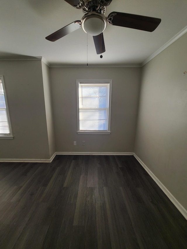 spare room with crown molding, ceiling fan, and dark wood-type flooring