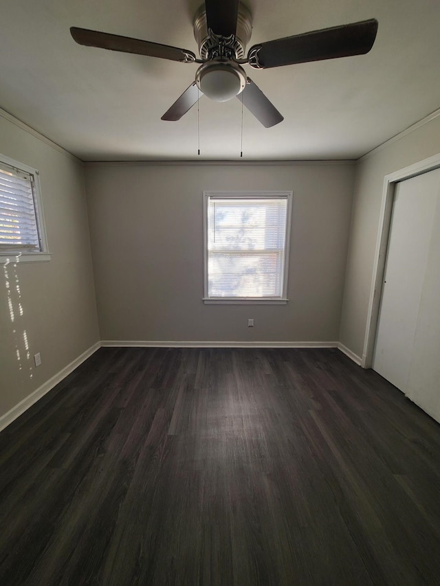 unfurnished room with ceiling fan and dark hardwood / wood-style flooring