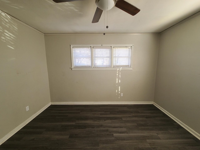 spare room with crown molding, dark hardwood / wood-style floors, and ceiling fan