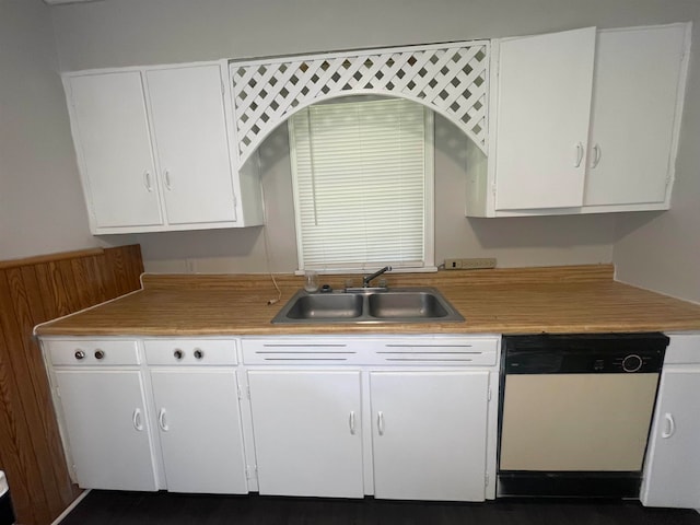 kitchen with white cabinets, white dishwasher, and sink