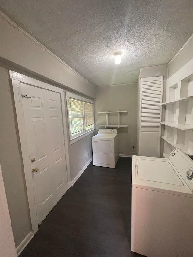 laundry area featuring a textured ceiling, independent washer and dryer, and dark hardwood / wood-style flooring