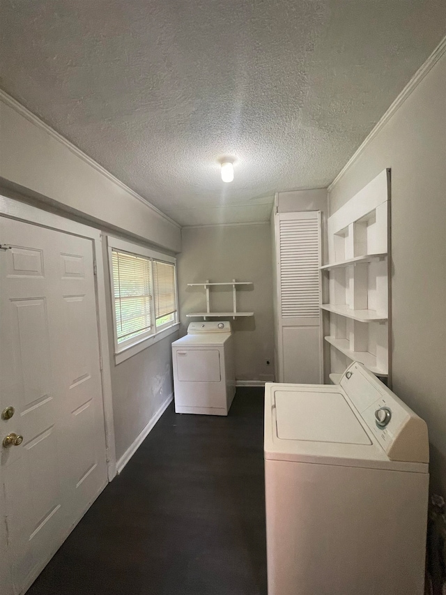 washroom with a textured ceiling, crown molding, washer and clothes dryer, and dark hardwood / wood-style flooring