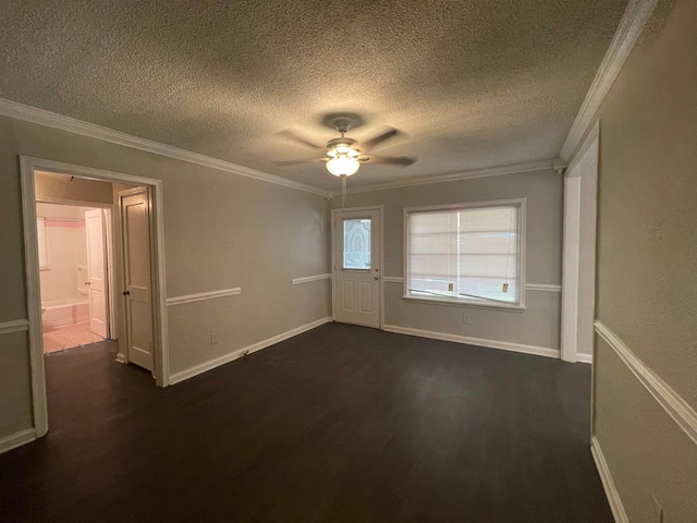 spare room with a textured ceiling, crown molding, dark hardwood / wood-style flooring, and ceiling fan