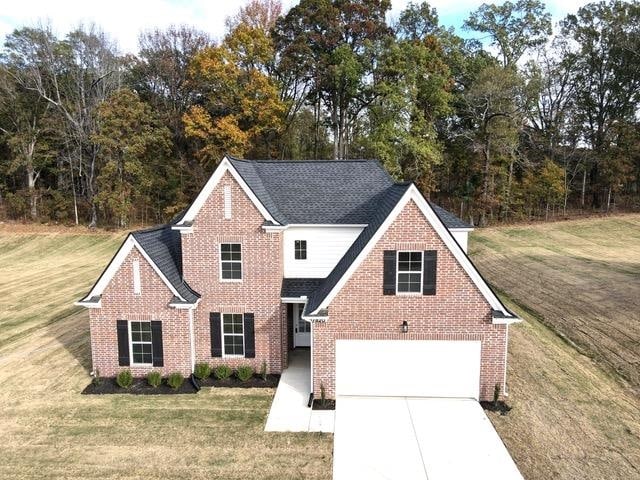 view of front of house featuring a garage and a front lawn