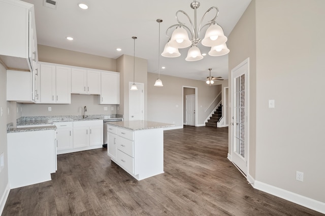 kitchen featuring pendant lighting, white cabinets, a center island, and dark wood-type flooring