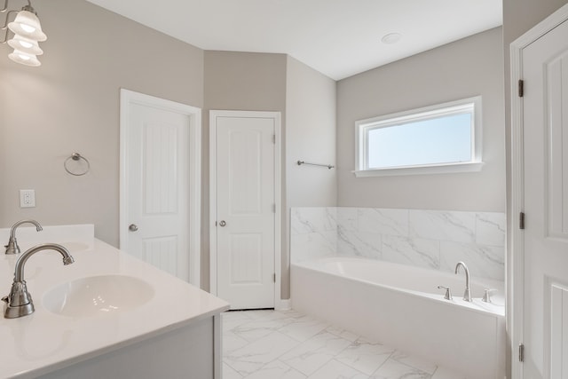 bathroom featuring a tub to relax in and vanity