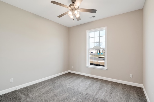 carpeted spare room featuring ceiling fan