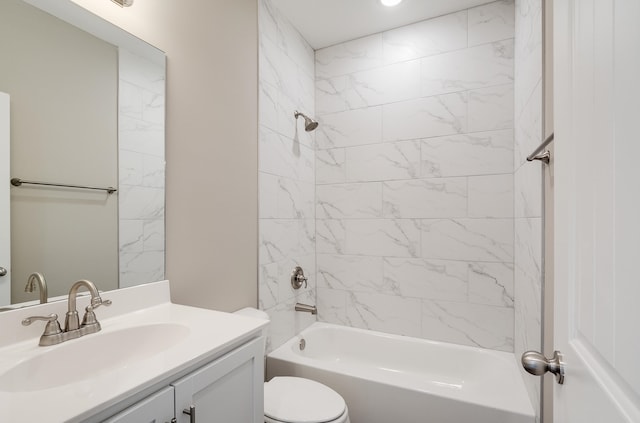 full bathroom with vanity, tiled shower / bath, and toilet