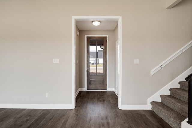 entryway with dark hardwood / wood-style flooring