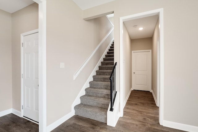 stairway with hardwood / wood-style flooring