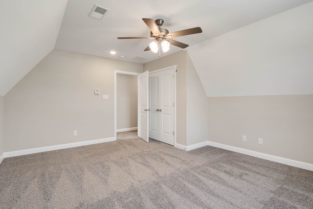 additional living space with vaulted ceiling, ceiling fan, and light colored carpet