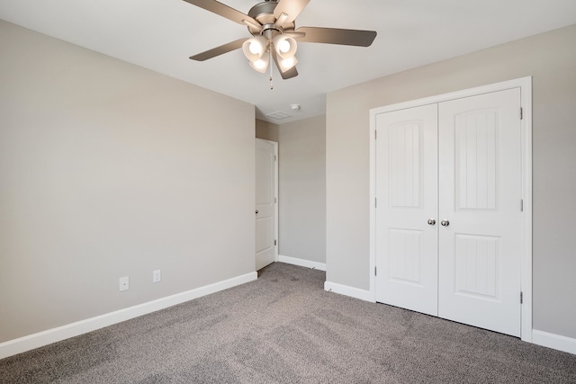 unfurnished bedroom with carpet flooring, ceiling fan, and a closet