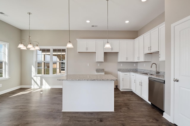 kitchen with stainless steel dishwasher, white cabinetry, dark hardwood / wood-style floors, and pendant lighting