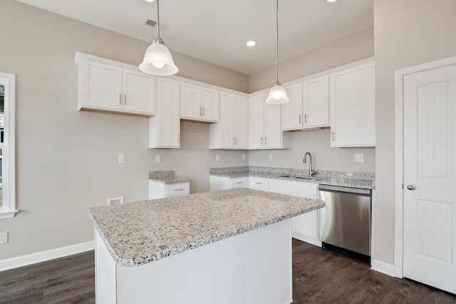 kitchen featuring dishwasher, a kitchen island, sink, and white cabinetry