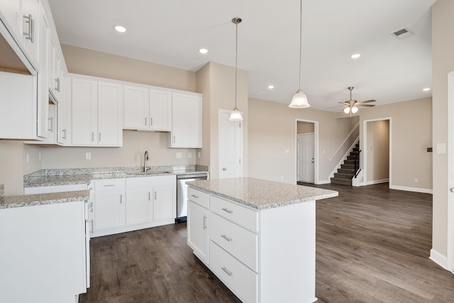 kitchen featuring white cabinets, dark hardwood / wood-style floors, a kitchen island, and sink