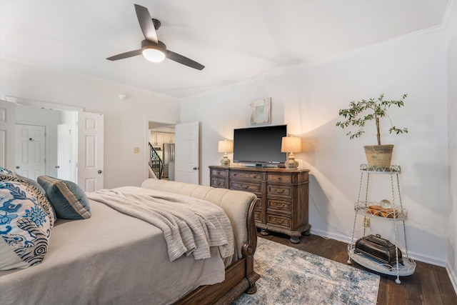 bedroom with ceiling fan, ornamental molding, and dark wood-type flooring