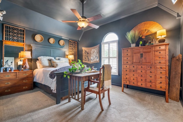 bedroom with vaulted ceiling, ceiling fan, carpet flooring, and crown molding