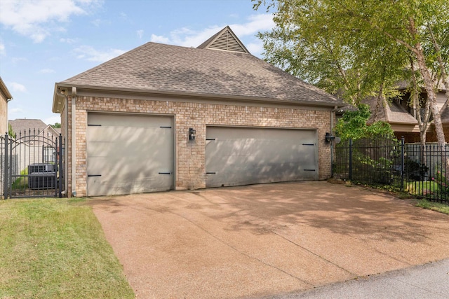 view of front facade with a garage and central air condition unit