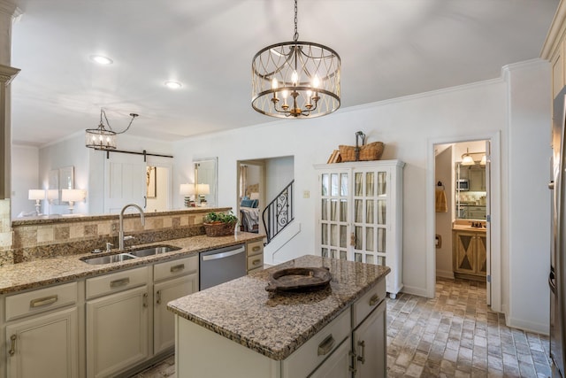 kitchen featuring light stone counters, sink, a kitchen island, dishwasher, and a barn door