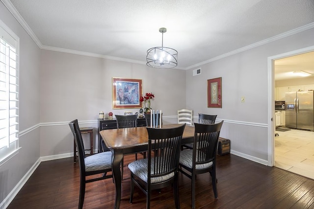 7150 Woodridge Ln, Germantown, TN 38138 - dining area featuring wood finished floors, a healthy amount of sunlight, ornamental molding, and an inviting chandelier