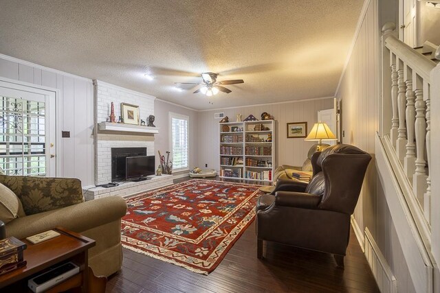 7150 Woodridge Ln, Germantown, TN 38138 - living room with dark wood finished floors, a ceiling fan, and crown molding