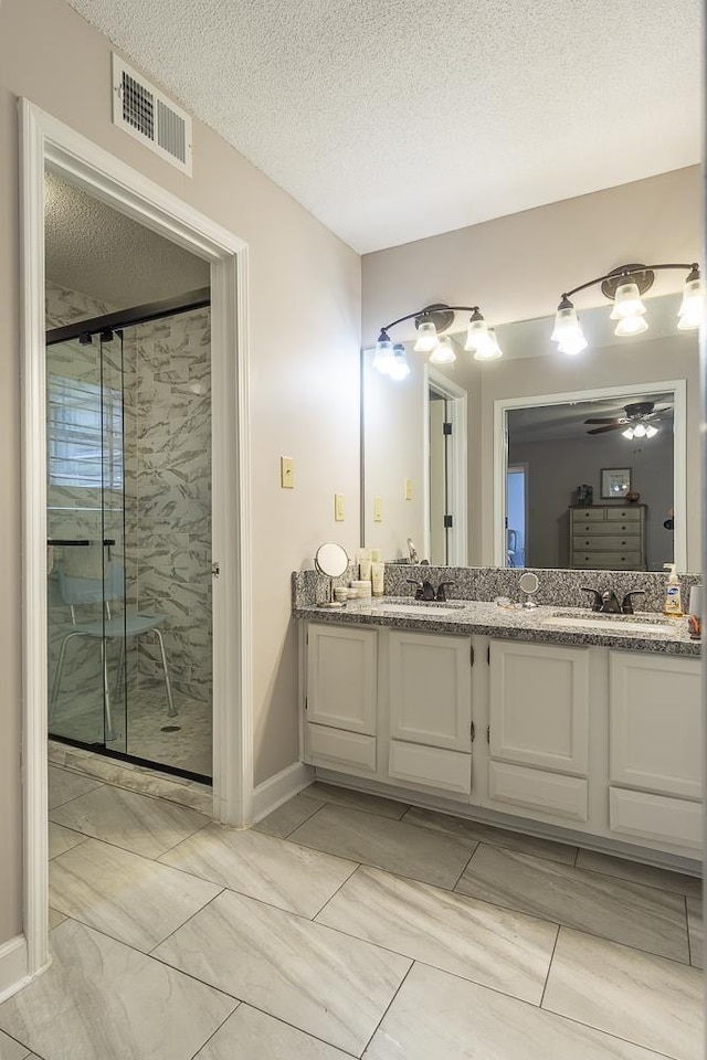 7150 Woodridge Ln, Germantown, TN 38138 - full bath featuring a shower stall, double vanity, visible vents, a sink, and ceiling fan