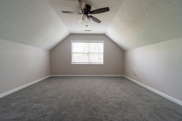 bonus room with ceiling fan, carpet flooring, a textured ceiling, and vaulted ceiling