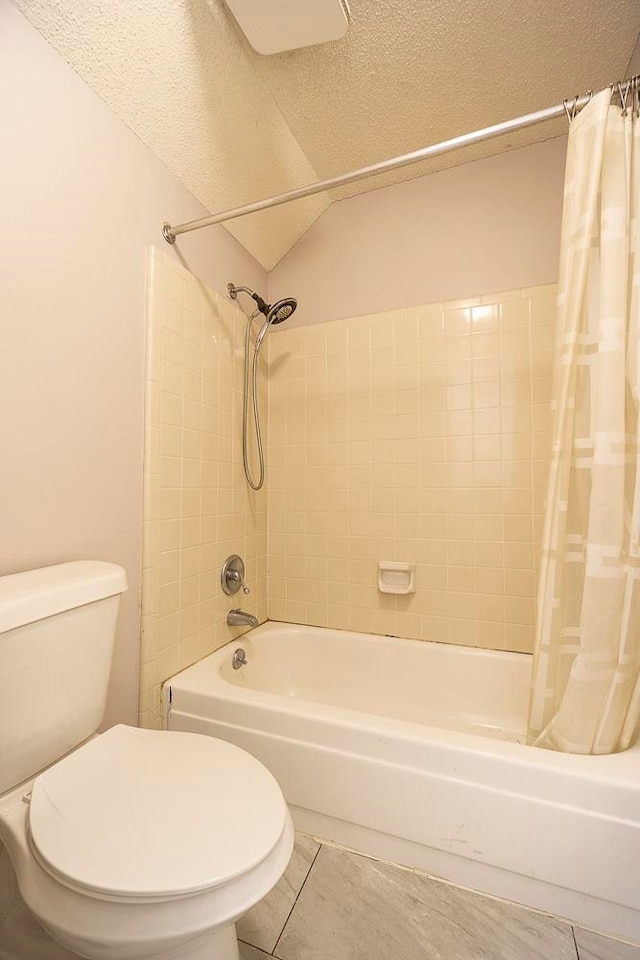 bathroom with shower / tub combo with curtain, a textured ceiling, tile patterned floors, and toilet