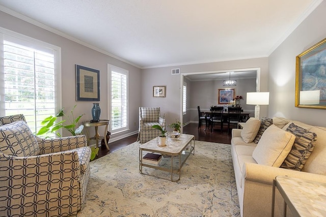 7150 Woodridge Ln, Germantown, TN 38138 - living area with wood finished floors, visible vents, and crown molding