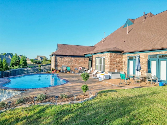 view of swimming pool with a lawn and a patio