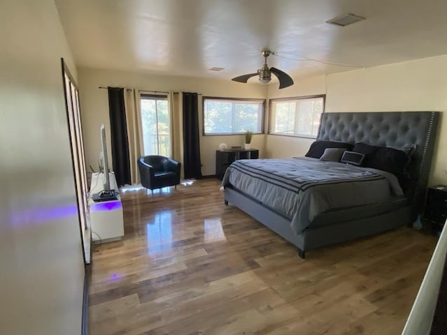 bedroom with wood-type flooring and ceiling fan