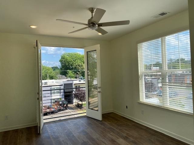 doorway featuring ceiling fan, plenty of natural light, and dark wood-type flooring