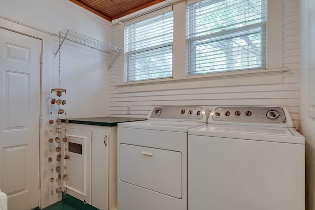 clothes washing area with separate washer and dryer and wooden ceiling