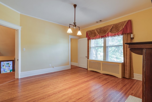 interior space with radiator heating unit, hardwood / wood-style flooring, and crown molding