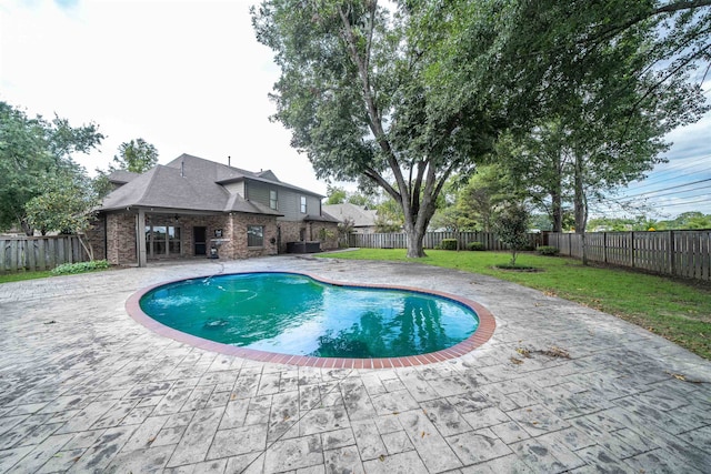 view of swimming pool with a lawn and a patio area