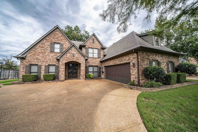 view of front of property with a garage and a front lawn