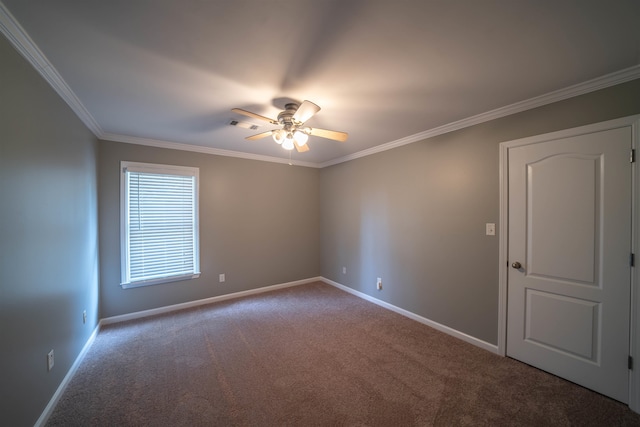 empty room with ceiling fan, carpet floors, and crown molding