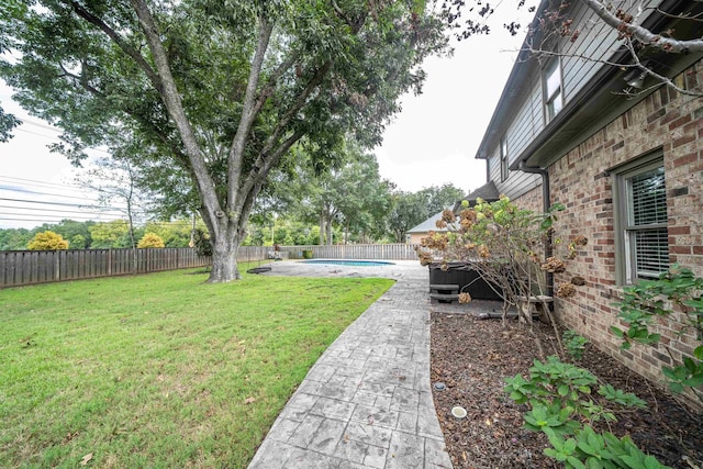 view of yard with a fenced in pool