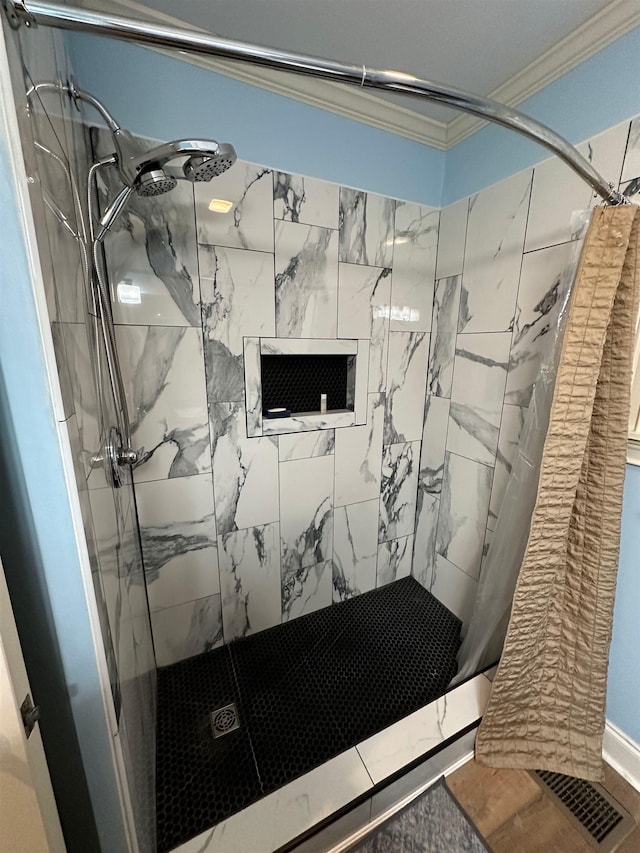 bathroom featuring a shower with curtain and crown molding