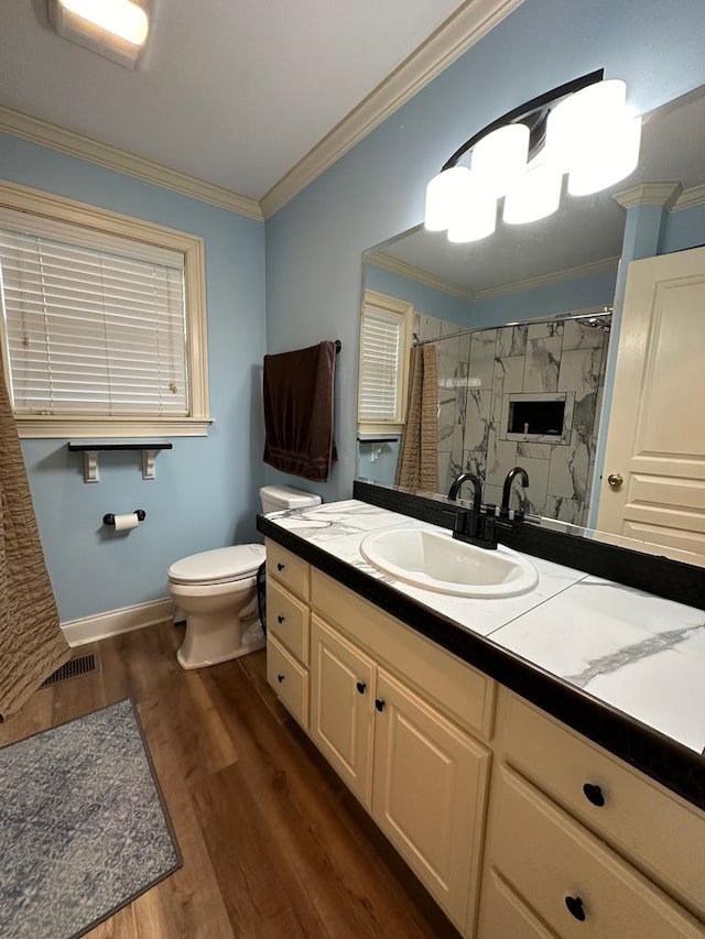 bathroom with hardwood / wood-style flooring, a shower with curtain, crown molding, vanity, and toilet