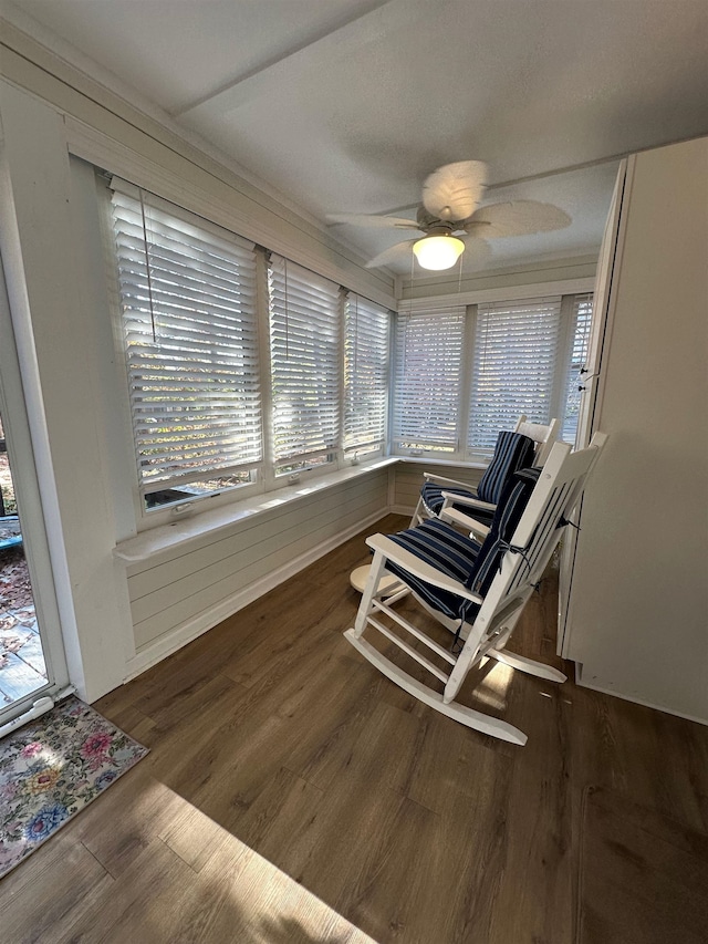 living area with dark hardwood / wood-style floors and ceiling fan