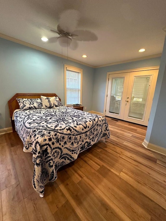 bedroom featuring french doors, light hardwood / wood-style floors, ceiling fan, and crown molding